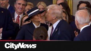 Sealed with a (air) kiss: Trump embraces Melania during inauguration arrival